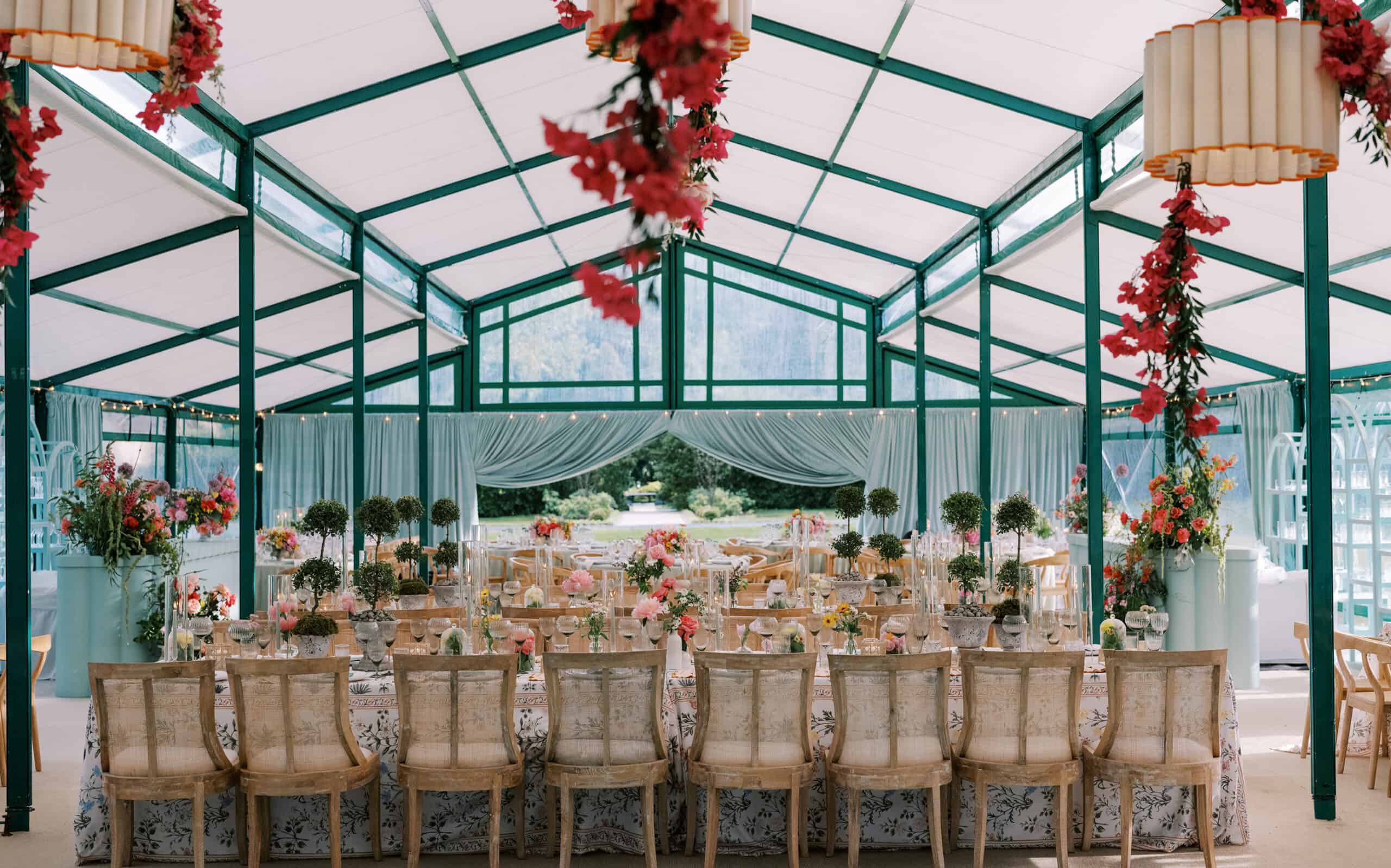 KathleenRob5-3-25GlenstoneGardenVA-VickiGraftonPhotography-825 Beautiful floral arrangements and vintage chairs under a glass tent.